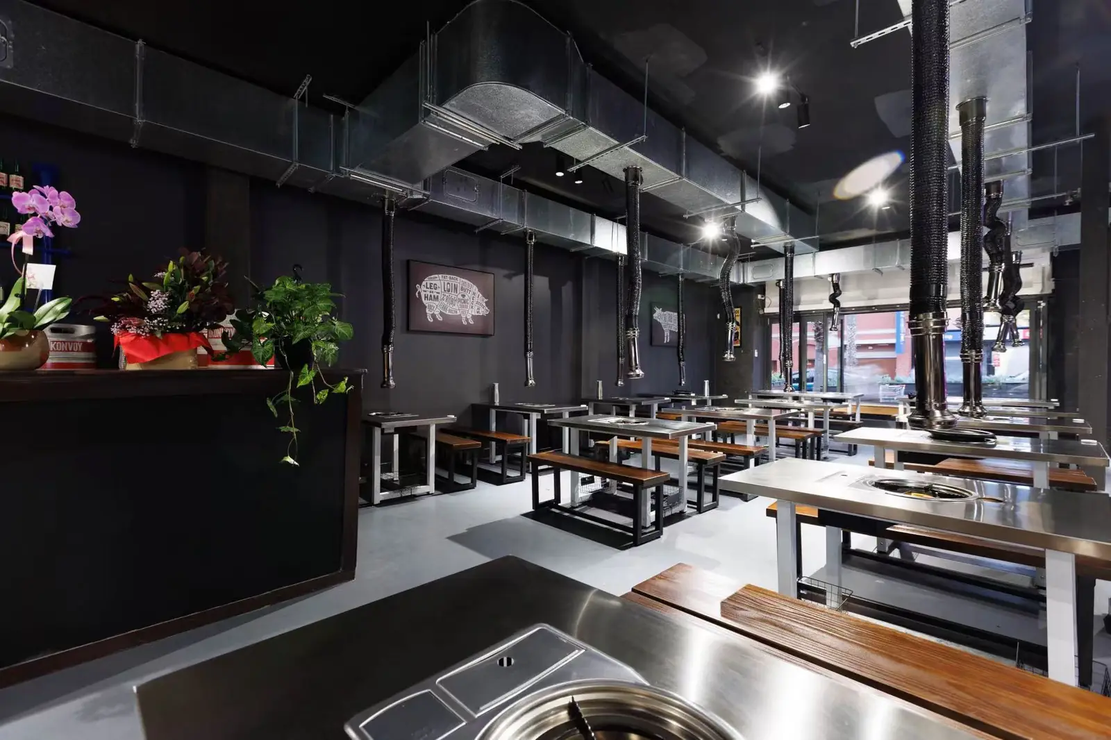 Guests sharing Korean barbecue and hot pot at a GOGI dining table