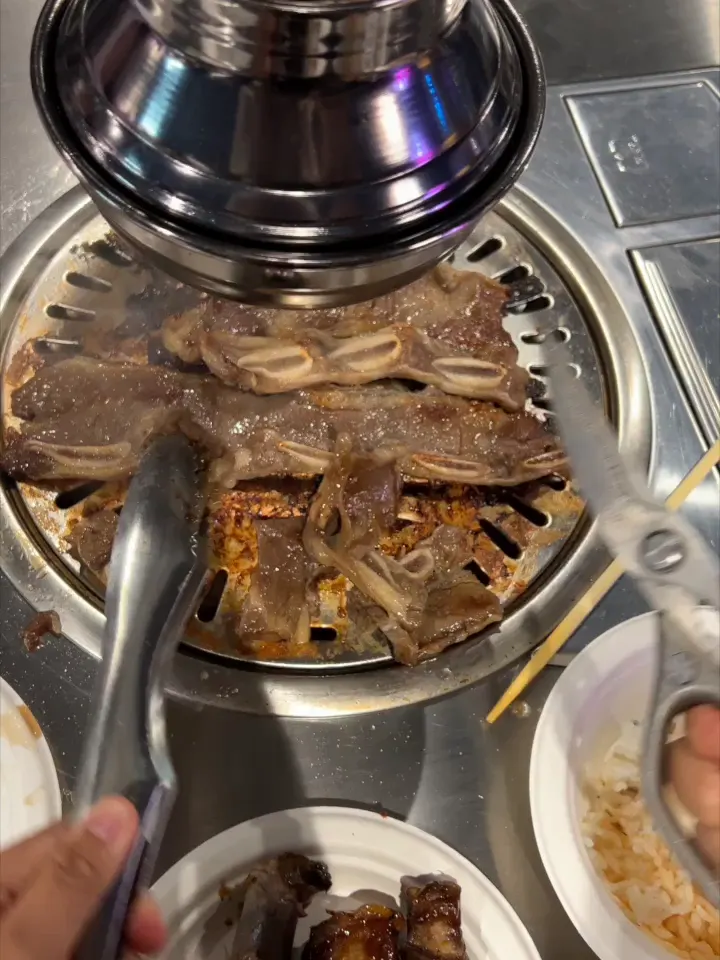 Marinated beef grilling on a tabletop grill at GOGI